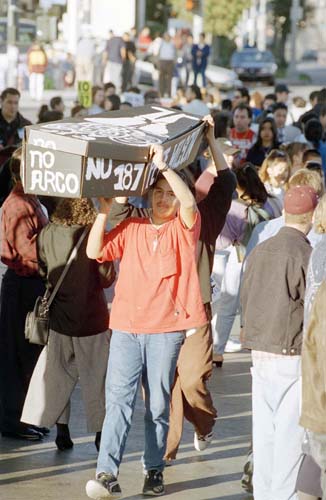 Protesters who oppose Proposition 187 carry out a mock funeral for the immigration initiative and Gov. Pete Wilson during a rally in Los Angeles, Nov. 3, 1994.